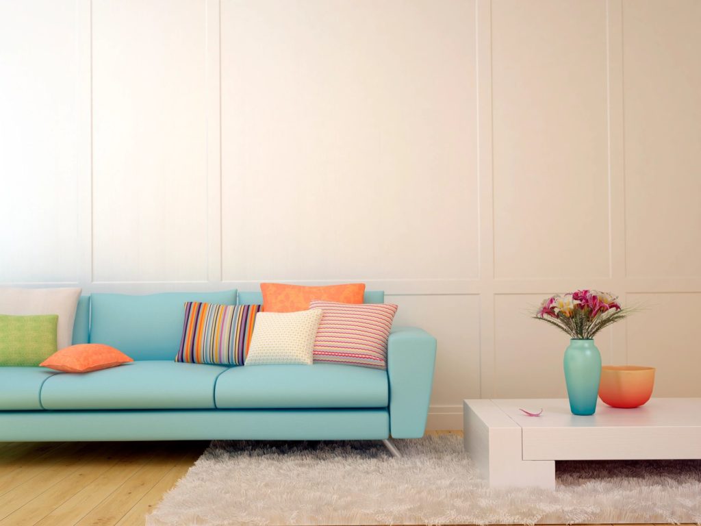 Light blue sofa with colorful pillows.